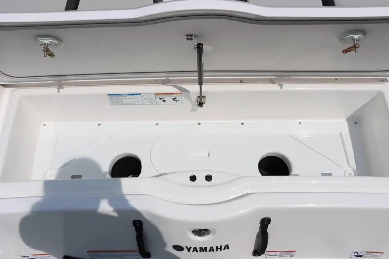 Slide: The Image of 2024 Yamaha AR250 boat storage compartment with open lid. - 9