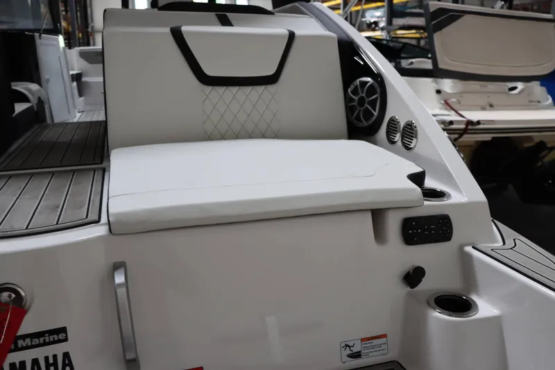 Slide: The Image of 2024 Yamaha Boats 222SD interior with white seating and audio system. - 10