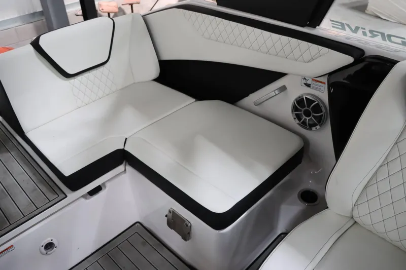 Slide: The Image of 2024 Yamaha Boats 222SD interior seating with white upholstery and speaker detail. - 18
