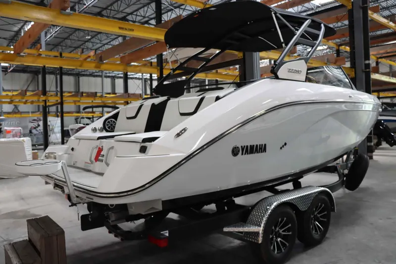 Slide: The Image of 2024 Yamaha Boats 222SD on trailer in warehouse setting. - 3