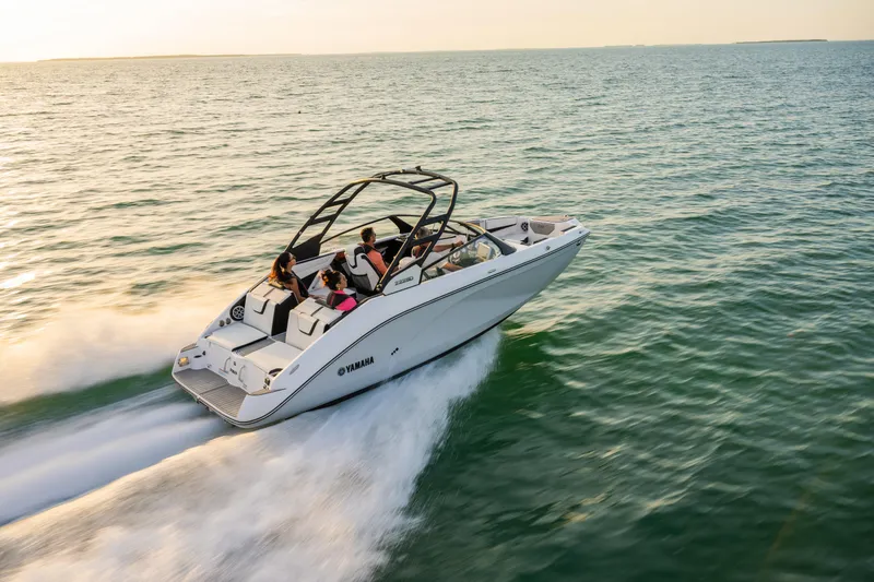 Slide: The Image of 2024 Yamaha Boats 222SD cruising on open water at sunset. - 31