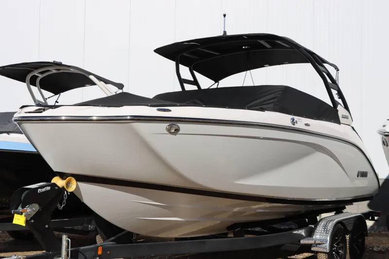 Slide: The Image of 2024 Yamaha Boats 222SD, sleek white design, on trailer, ready for adventure. - 5