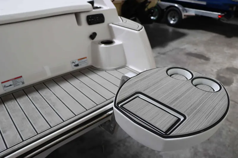 Slide: The Image of 2024 Yamaha Boats 222SD swim platform with cup holders and storage. - 8