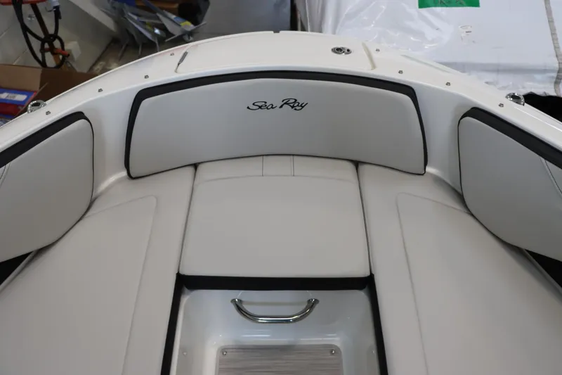 Slide: The Image of 2024 Sea Ray 210SPX boat interior with white cushioned seating. - 11