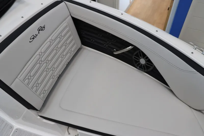 Slide: The Image of 2024 Sea Ray 210SPX boat interior with cushioned seating and speaker. - 12