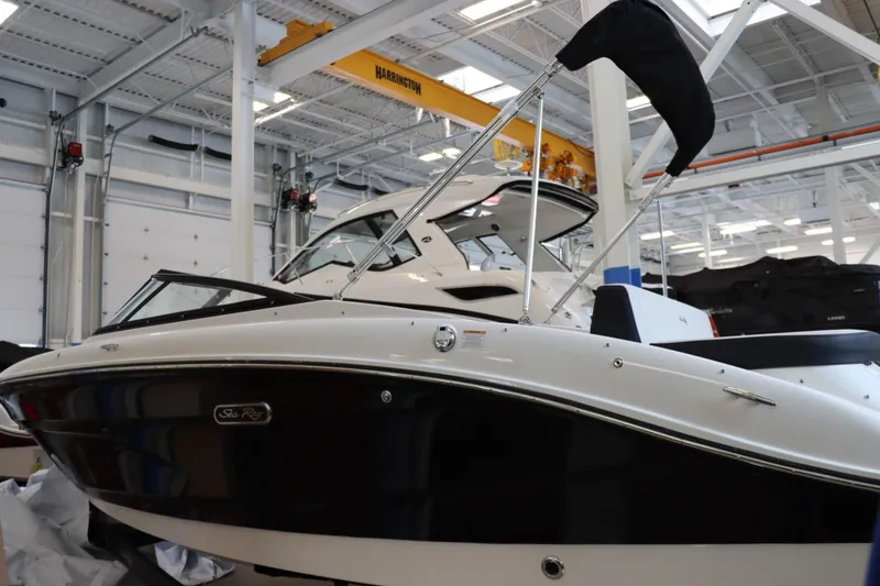 Slide: The Image of 2024 Sea Ray 210SPX boat in a showroom. - 4