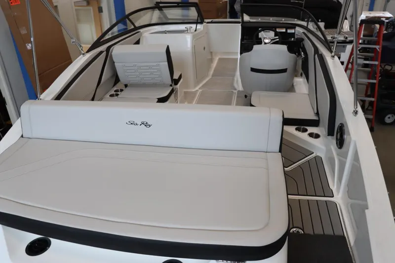 Slide: The Image of 2024 Sea Ray 210SPX boat interior with white seating and modern design. - 5