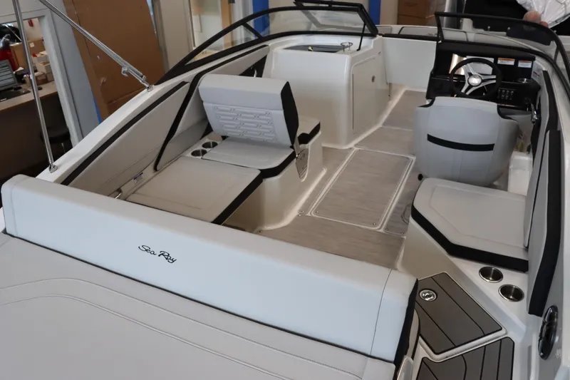 Slide: The Image of 2024 Sea Ray 210SPX boat interior with modern seating and steering console. - 6