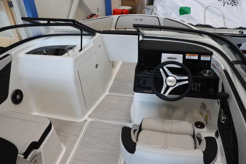 Slide: The Image of 2024 Sea Ray 210SPX boat interior with steering wheel and seating. - 7