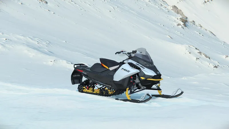 Slide: The Image of 2024 SKI DOO MXZ ADR BLIZZARD 137 850 ETEC snowmobile on snowy terrain. - 8