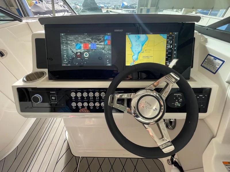 Slide: The Image of 2024 Sea Ray 350 SLX helm with advanced navigation and control systems. - 10