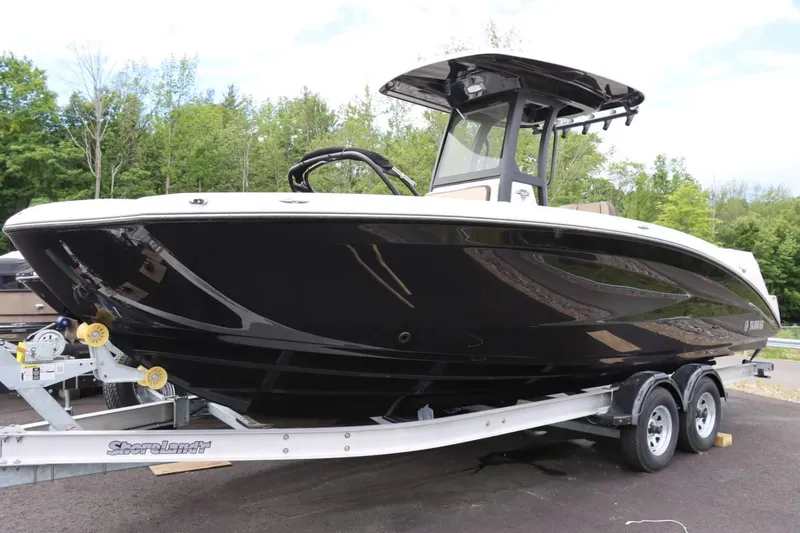 Slide: The Image of 2023 Yamaha Boats 255FSH SPORT E on trailer, black hull, outdoor setting. - 1