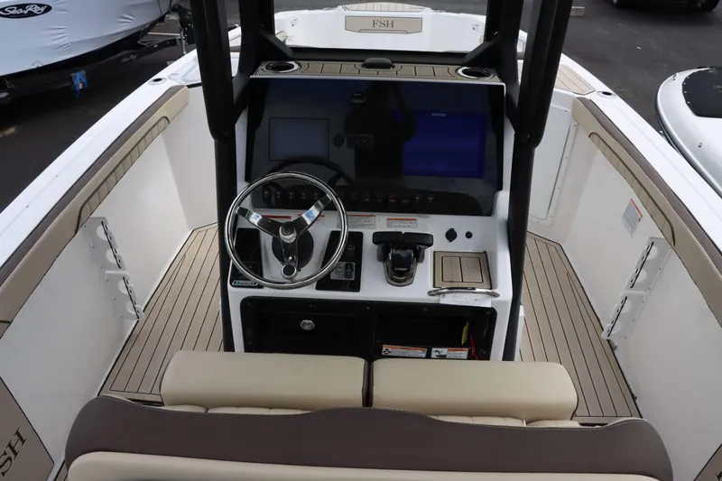 Slide: The Image of 2023 Yamaha Boats 255FSH SPORT E helm station with steering wheel and controls. - 11