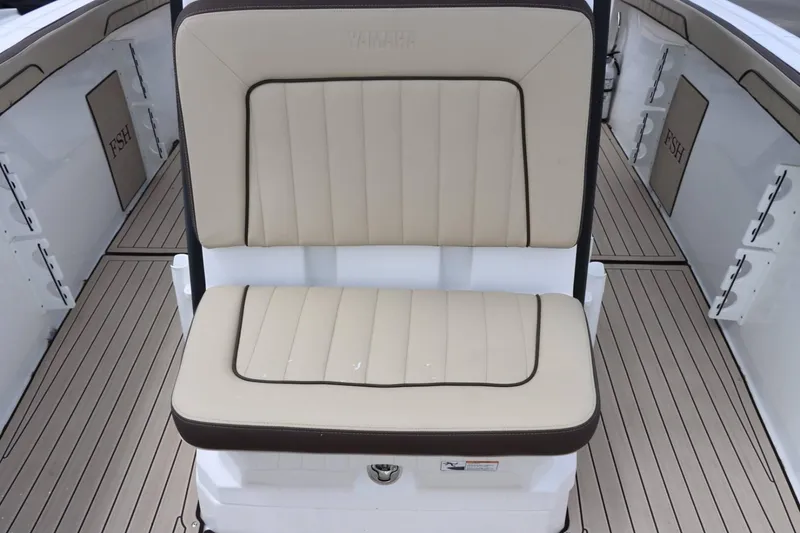 Slide: The Image of Yamaha Boats 2023 255FSH SPORT E interior seating with beige upholstery and deck flooring. - 14