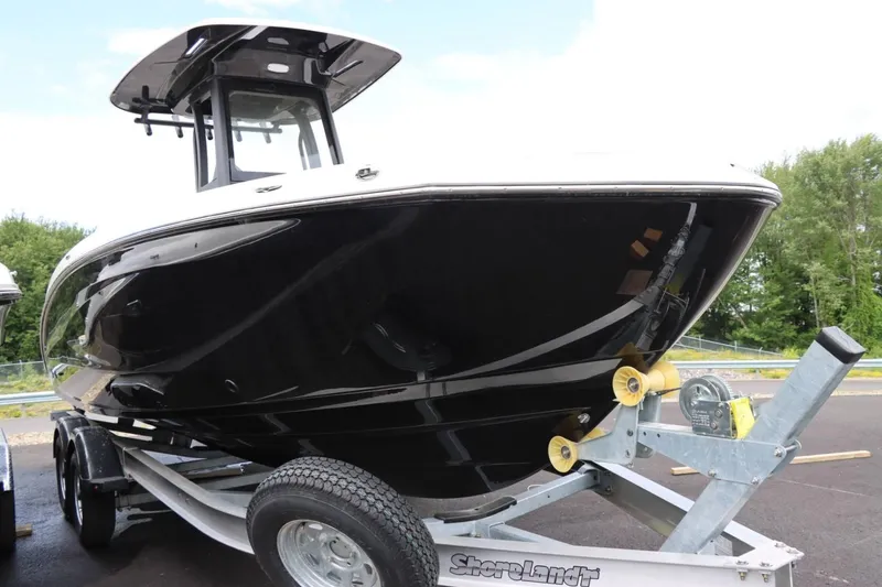 Slide: The Image of 2023 Yamaha Boats 255FSH SPORT E on trailer, black hull, side view. - 3