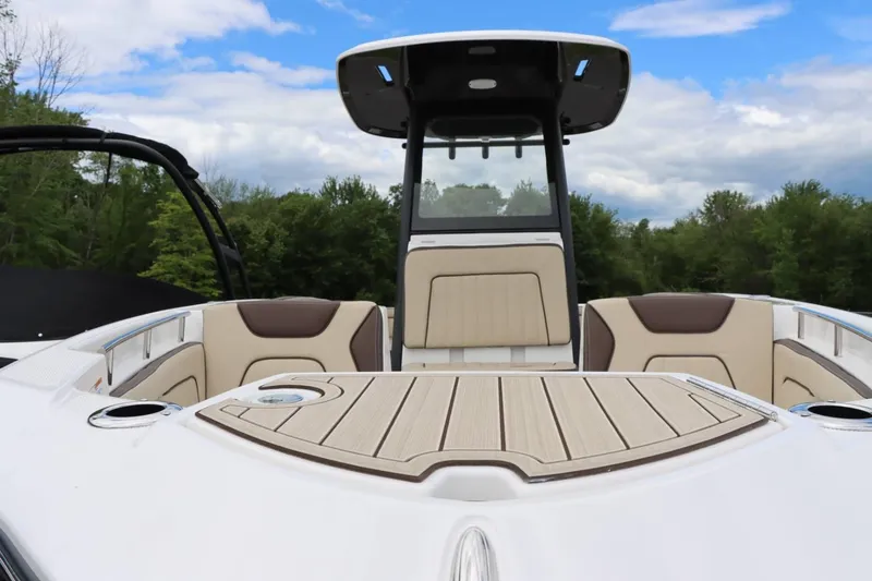 Slide: The Image of 2023 Yamaha Boats 255FSH SPORT E, interior view with seating and console. - 4