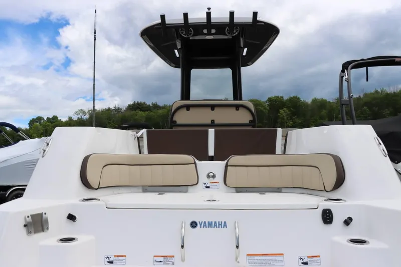 Slide: The Image of 2023 Yamaha Boats 255FSH SPORT E, rear view with seating and rod holders. - 6