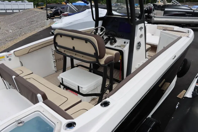 Slide: The Image of 2023 Yamaha Boats 255FSH SPORT E interior with seating and console. - 7