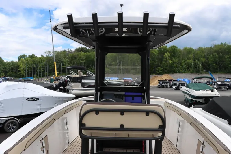 Slide: The Image of 2023 Yamaha Boats 255FSH SPORT E center console at a marina with other boats. - 9