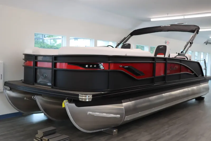 Slide: The Image of 2024 Barletta Corsa 23UC pontoon boat in showroom, featuring sleek design and modern amenities. - 1