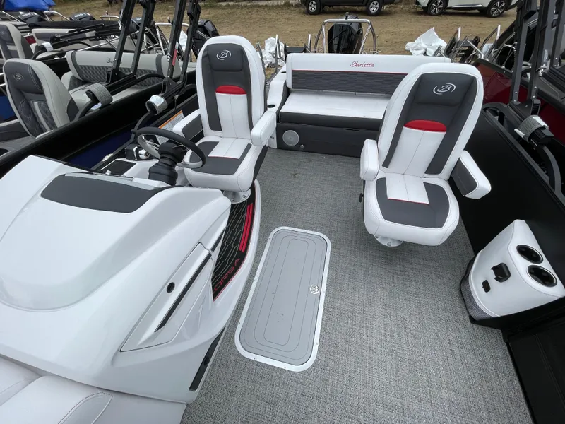 Slide: The Image of 2024 Barletta Corsa 23UC boat interior with captain's chairs and steering console. - 10