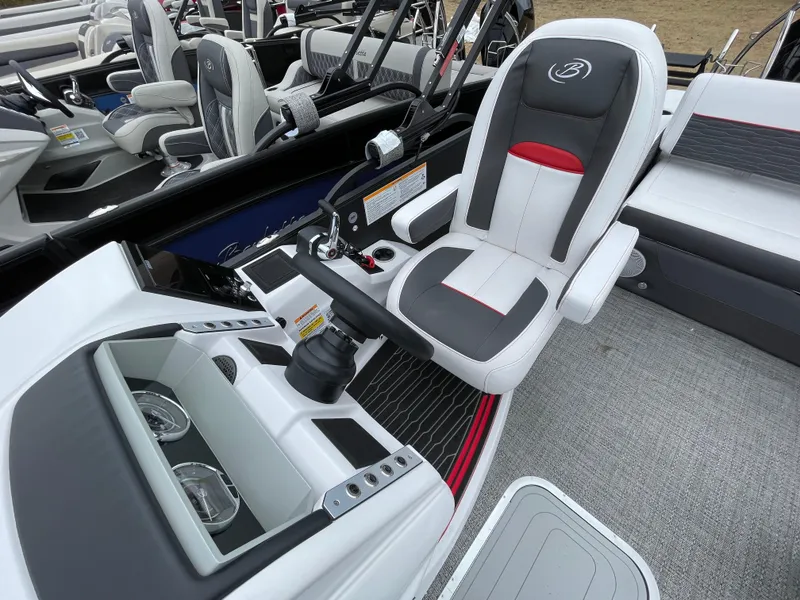 Slide: The Image of 2024 Barletta Corsa 23UC boat interior with captain's chair and control console. - 11