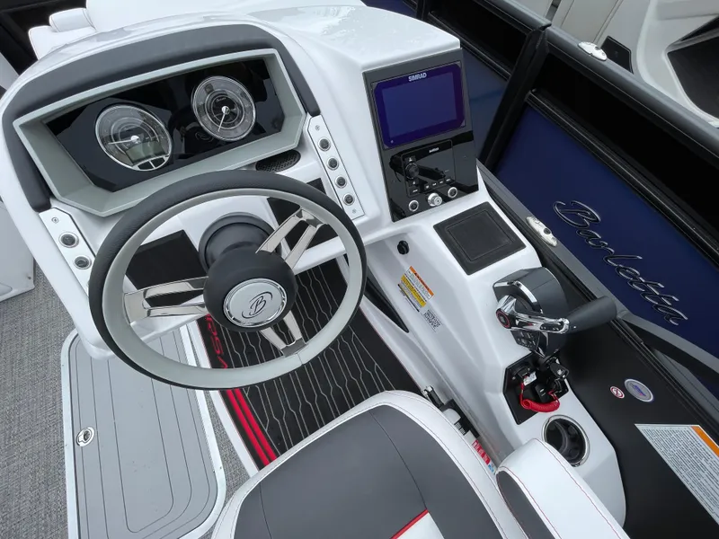 Slide: The Image of 2024 Barletta Corsa 23UC boat dashboard with steering wheel and control panel. - 7