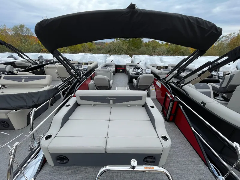 Slide: The Image of 2024 Barletta Cabrio 24UC pontoon boat with spacious seating and modern design. - 14