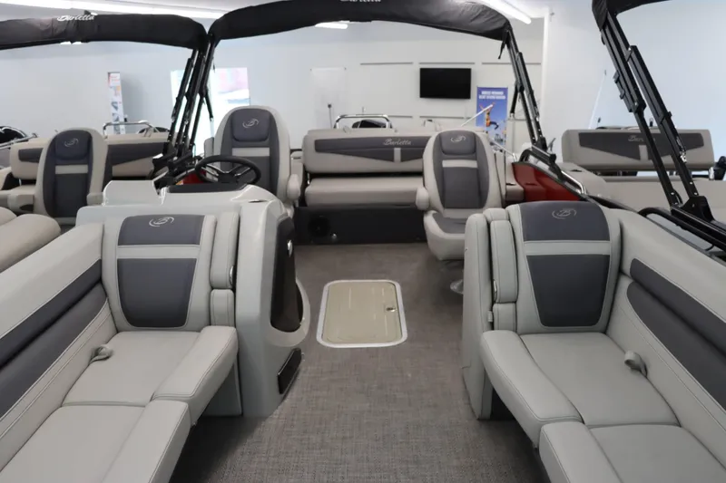 Slide: The Image of 2024 Barletta Cabrio 24UC pontoon boat interior with luxurious seating and modern design. - 19