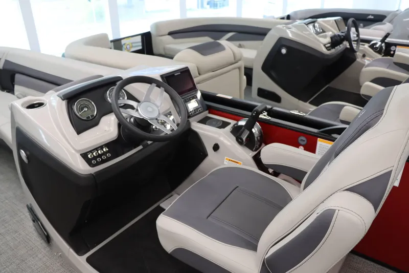 Slide: The Image of 2024 Barletta Cabrio 24UC boat interior with modern steering console and seating. - 8