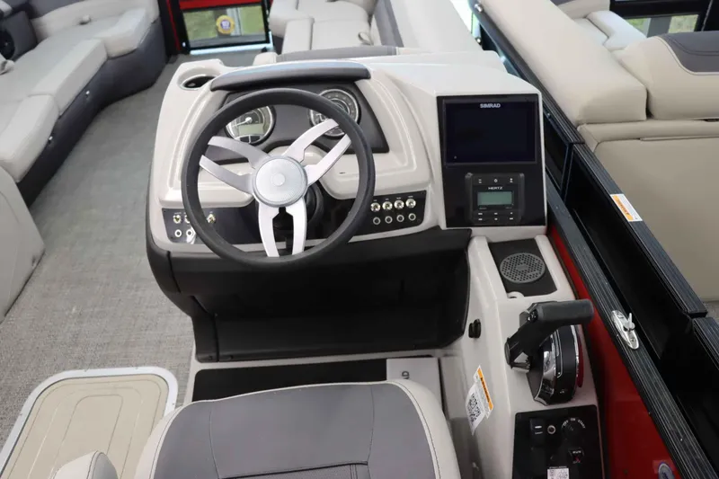 Slide: The Image of 2024 Barletta Cabrio 24UC boat dashboard with steering wheel and control panel. - 9