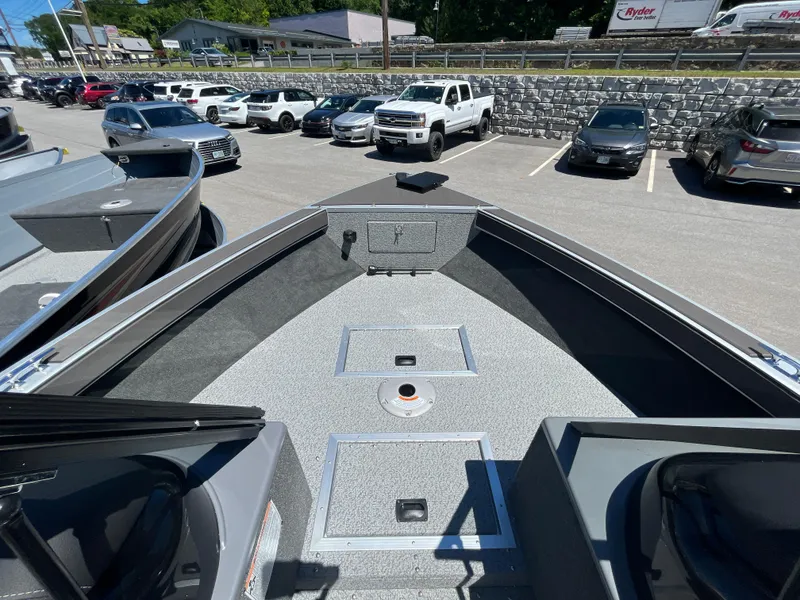 Slide: The Image of 2024 Starcraft Fishmaster 196 DC boat interior at a dealership parking lot. - 10
