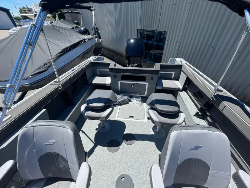 Slide: The Image of 2024 Starcraft Fishmaster 196 DC boat interior with seating and storage. - 11