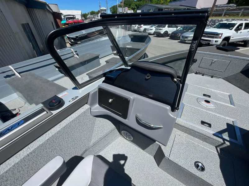 Slide: The Image of 2024 Starcraft Fishmaster 196 DC interior view with open windshield and seating area. - 13