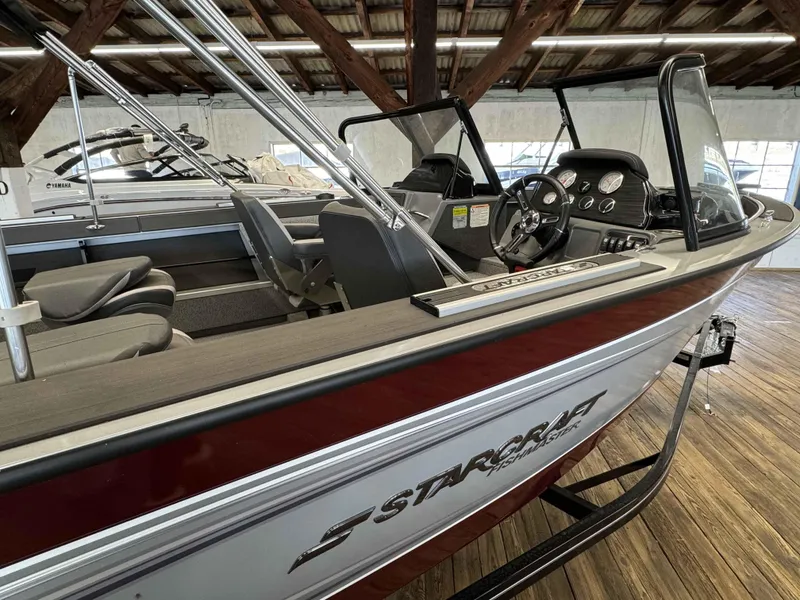 Slide: The Image of 2024 Starcraft Fishmaster 196 DC boat interior with steering console and seating. - 4
