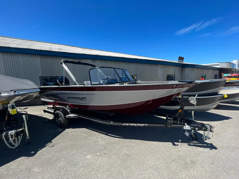 Slide: The Image of 2024 Starcraft Fishmaster 196 DC boat on a trailer in a dealership lot. - 5