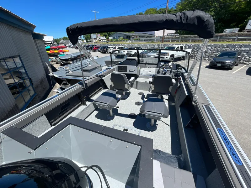 Slide: The Image of 2024 Starcraft Fishmaster 196 DC boat interior with seating and control console. - 7