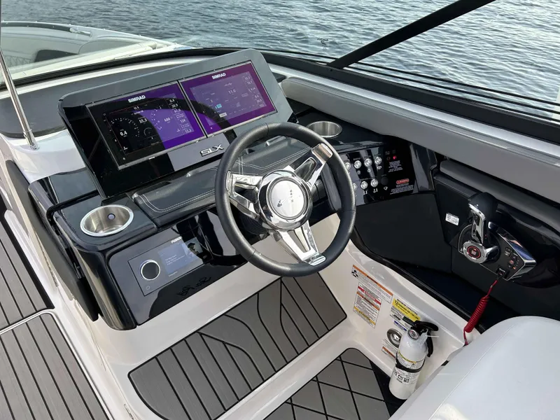 Slide: The Image of 2023 Sea Ray 260SXS boat dashboard with modern controls and dual displays. - 3