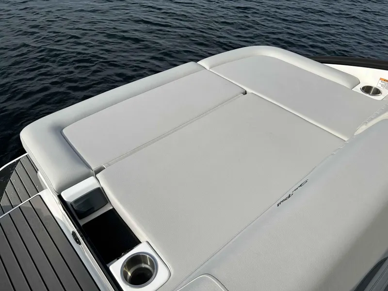 Slide: The Image of 2023 Sea Ray 260SXS boat with spacious sunpad on calm water. - 8