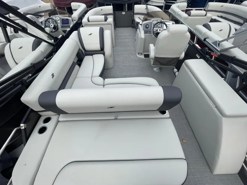 Slide: The Image of 2024 Starcraft EXS 3Q boat interior with plush seating and modern dashboard. - 10