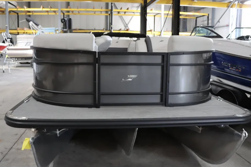 Slide: The Image of 2024 Starcraft EXS 3Q pontoon boat in a showroom. - 3