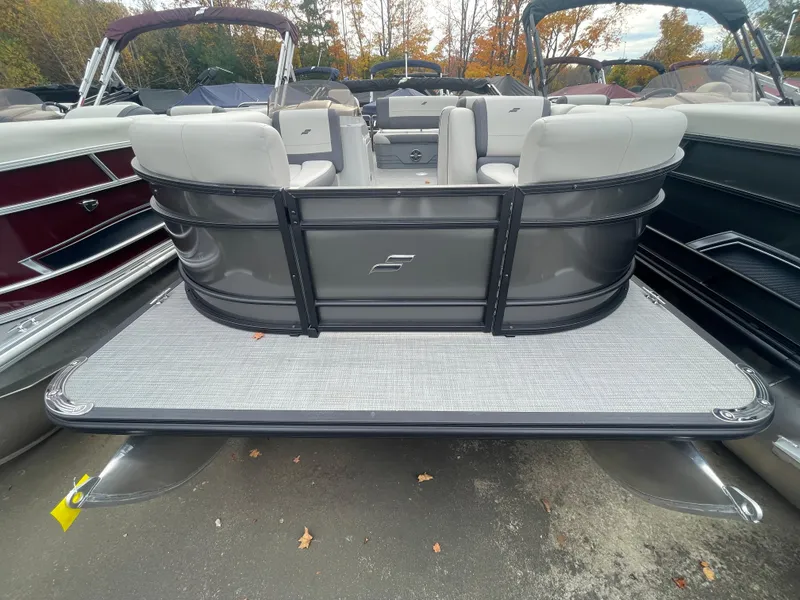 Slide: The Image of 2024 Starcraft EXS 3Q pontoon boat, rear view, docked among other boats. - 4