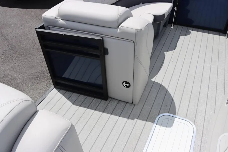 Slide: The Image of 2023 Starcraft CX 23DL Bar boat interior with white leather seating and storage compartment. - 13