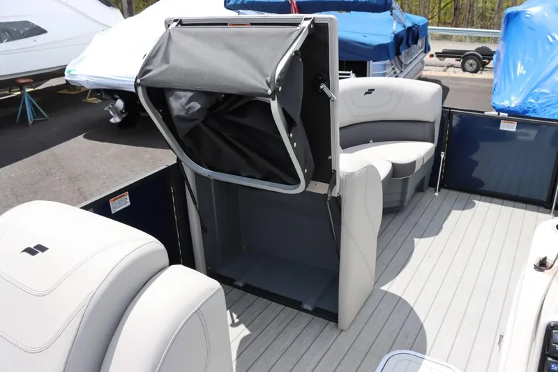 Slide: The Image of 2023 Starcraft CX 23DL Bar interior with seating and storage compartment. - 14