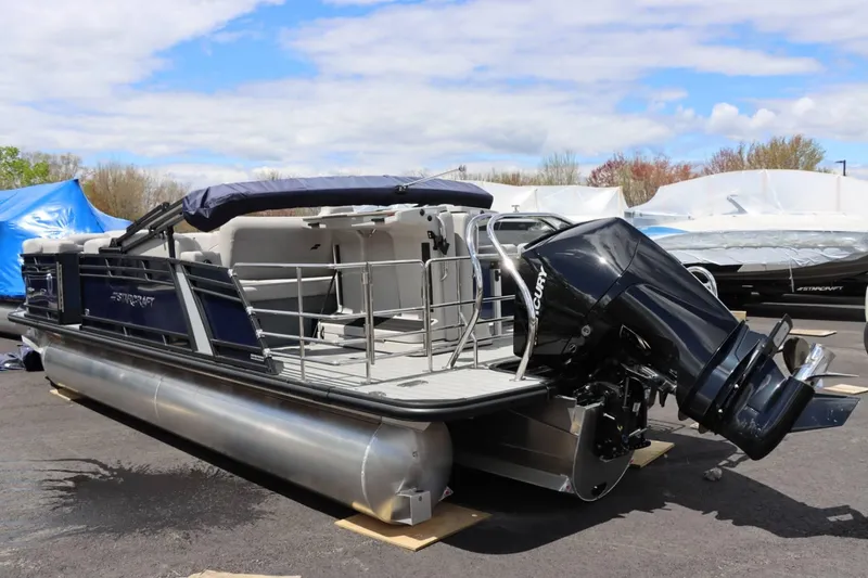 Slide: The Image of 2023 Starcraft CX 23DL Bar pontoon boat with outboard motor, docked on land. - 3