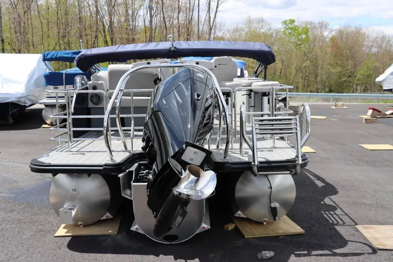 Slide: The Image of 2023 Starcraft CX 23DL Bar pontoon boat with outboard motor, docked on land. - 4