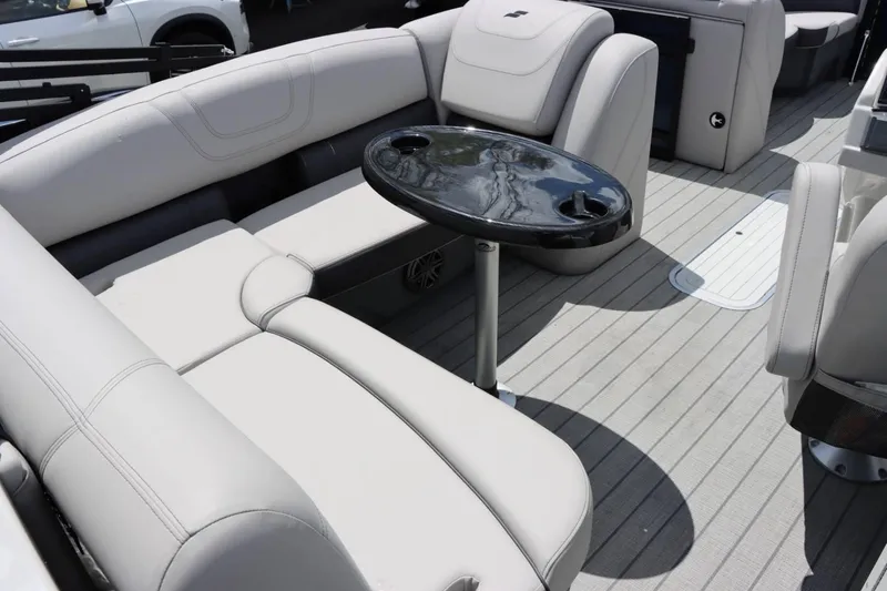 Slide: The Image of 2023 Starcraft CX 23DL Bar boat interior with plush seating and a central table. - 8
