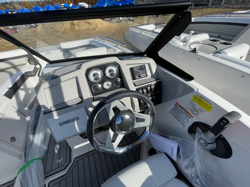Slide: The Image of 2024 Starcraft SVX 190 OB boat dashboard with steering wheel and control panel. - 19