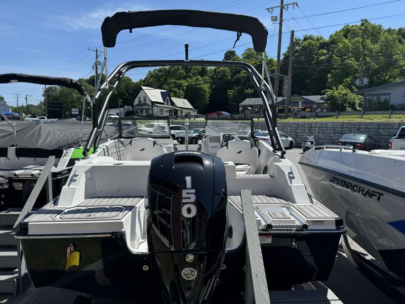 Slide: The Image of 2024 Starcraft SVX 190 OB boat with Mercury 150 outboard motor, docked at a marina. - 22