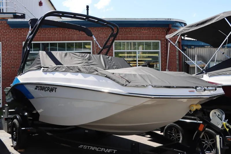 Slide: The Image of 2024 Starcraft SVX 190 OB boat on trailer, covered and parked outside. - 6